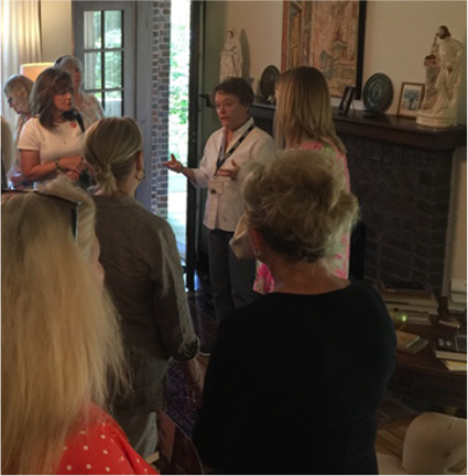 A volunteer docent gives a tour of the Eudora Welty House to a group of visitors.