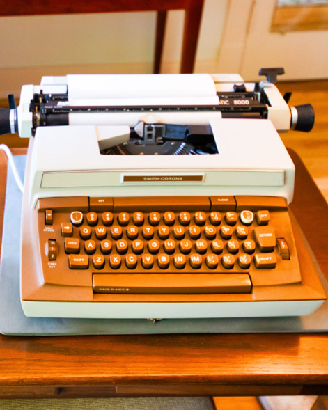 Front of Eudora Welty’s Smith-Corona electric typewriter on the wooden desk in her bedroom at the Eudora Welty House & Garden.