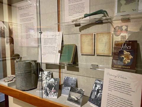 Eudora Welty's watering can, handrake, gardening book, family photos, and her mother's garden journals are among the artifacts on display at the Eudora Welty House & Garden Visitor Center for A Parade of Bloom: Stories from the Welty Garden