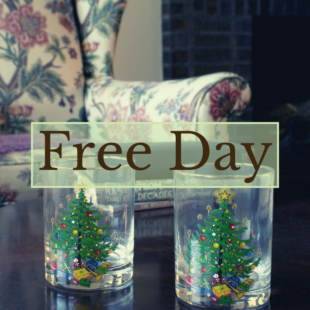 Two clear glasses with colorful Christmas tree designs sit on a table, with floral upholstery in the background. The words 'Free Day' appear in bold brown letters within a green-bordered transparent box.