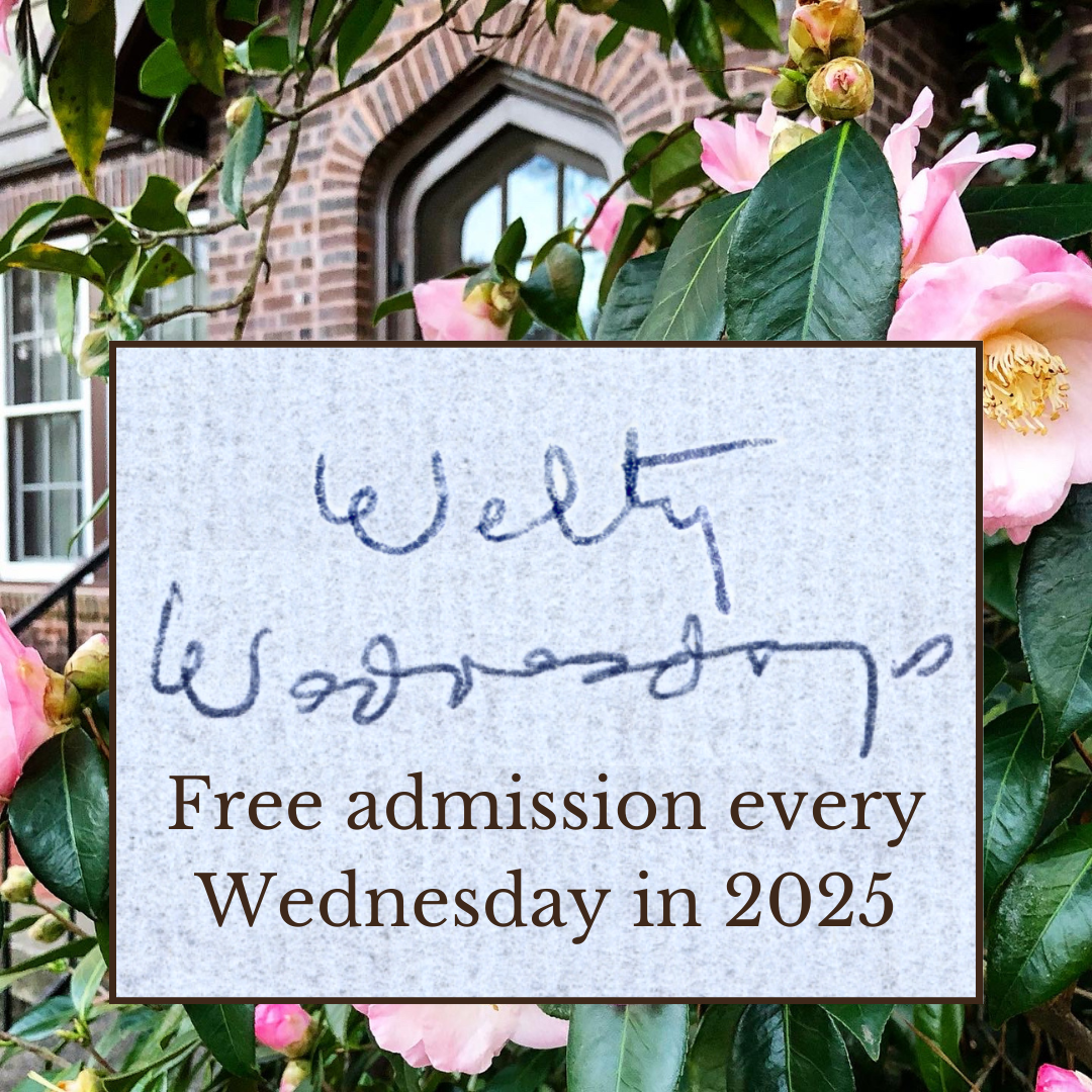 A close-up of pink camellias with green leaves in front of the brick exterior of the Eudora Welty House, showcasing an arched window. Superimposed is a box featuring Eudora Welty's handwritten text, 'Welty Wednesdays,' in blue ink on a textured background. Below the handwriting, printed text reads: 'Free admission every Wednesday in 2025.'